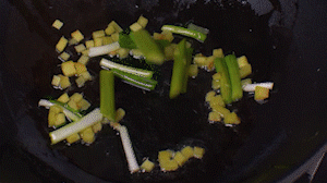 鍋中熱油，依次下姜粒、蔥段、蘆筍炒香。